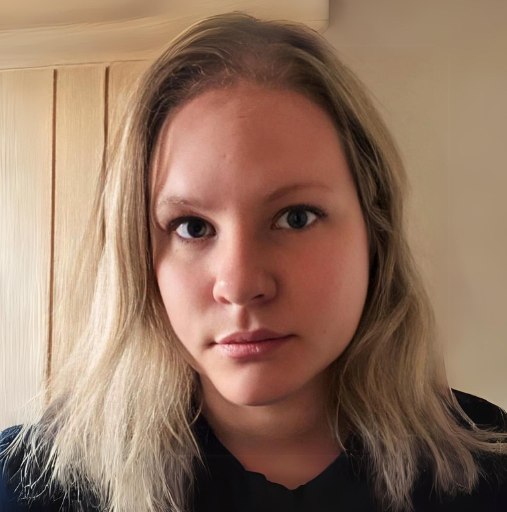 A woman with blonde hair is wearing a black shirt