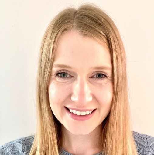 A woman with long blonde hair is smiling for the camera.