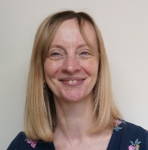 A woman with blonde hair is smiling for the camera