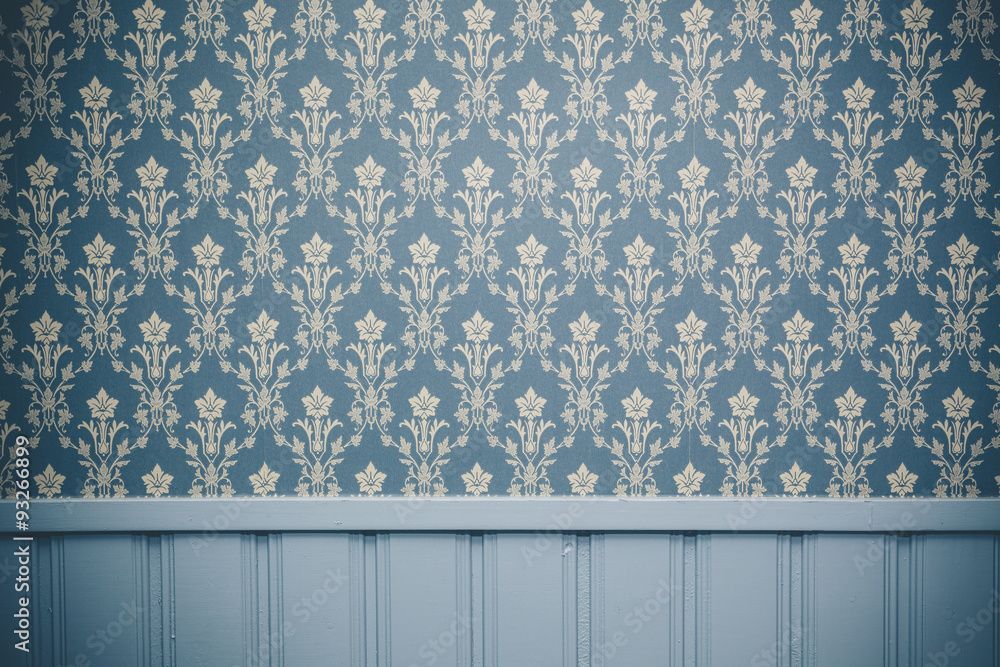 A room with a blue wallpaper and a wooden wall.