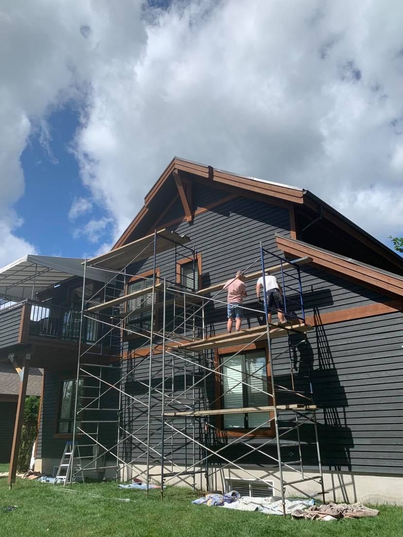 A house is being painted with scaffolding in front of it.