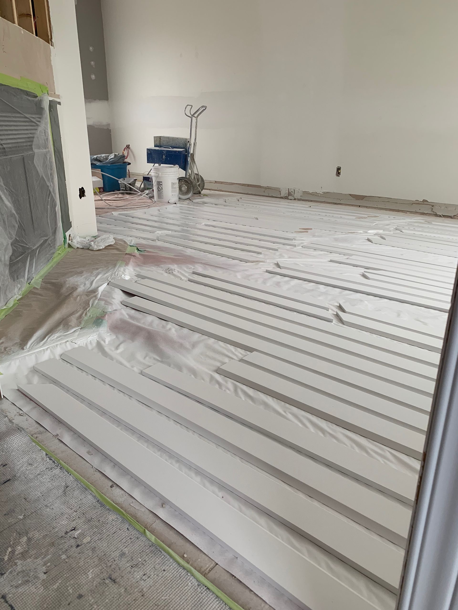 A room with a white floor covered in plastic.