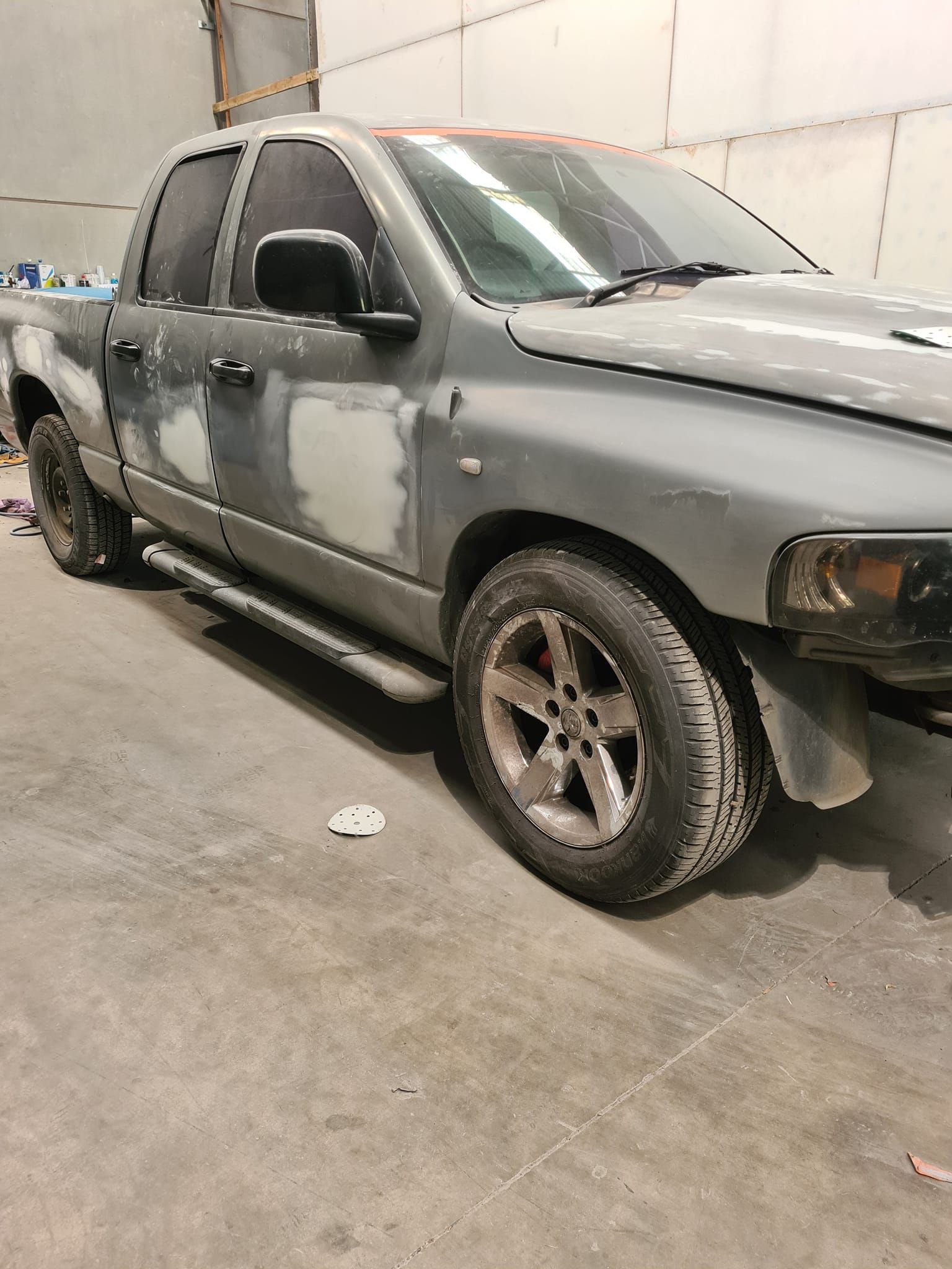 Grey SUV Parked Indoors With Dirt and Mud — A2B Smash Repairs in Newcastle, NSW