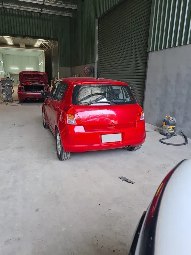 Red Hatchback Parked in a Garage — A2B Smash Repairs in Berkeley Vale, NSW
