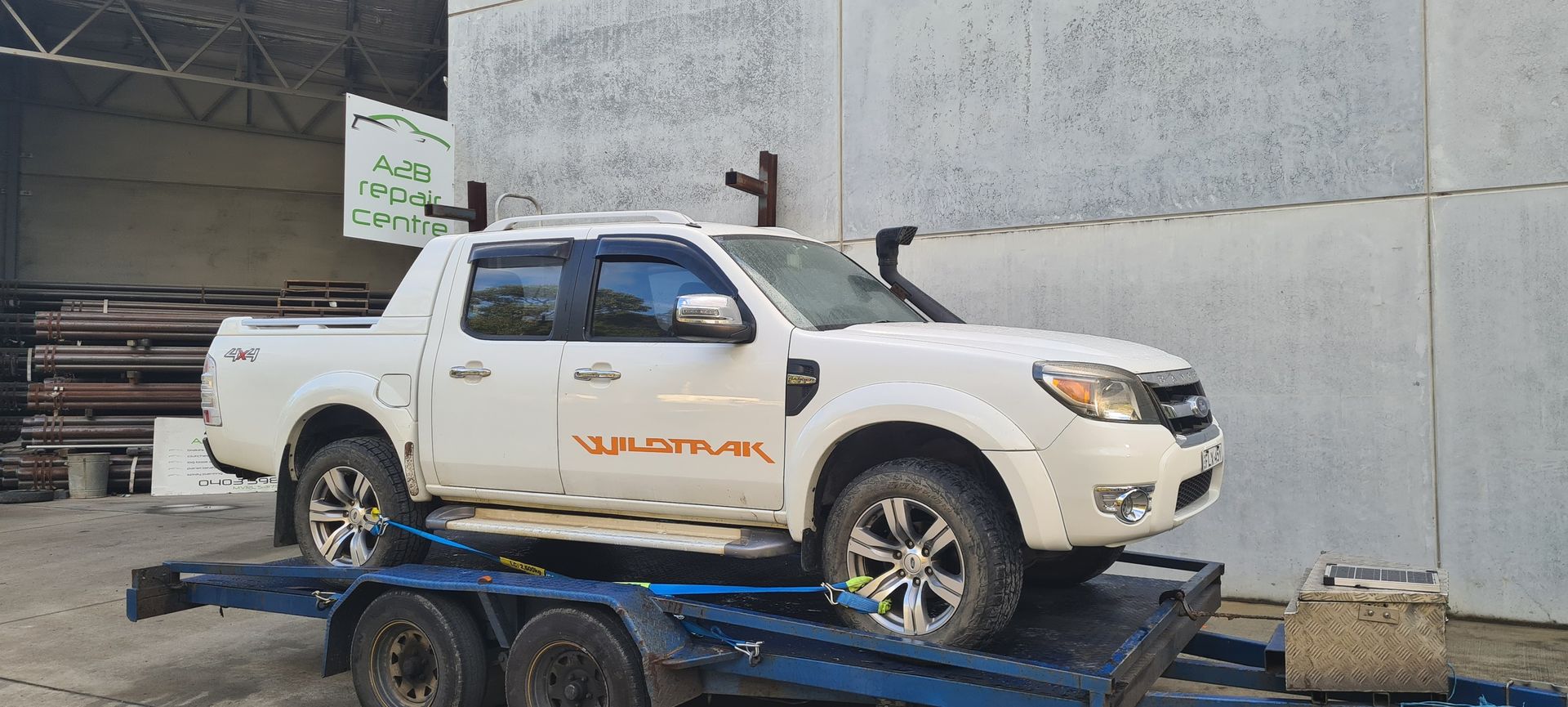 White Chevrolet Pickup Truck on a Blue Flatbed — A2B Smash Repairs in Berkeley Vale, NSW