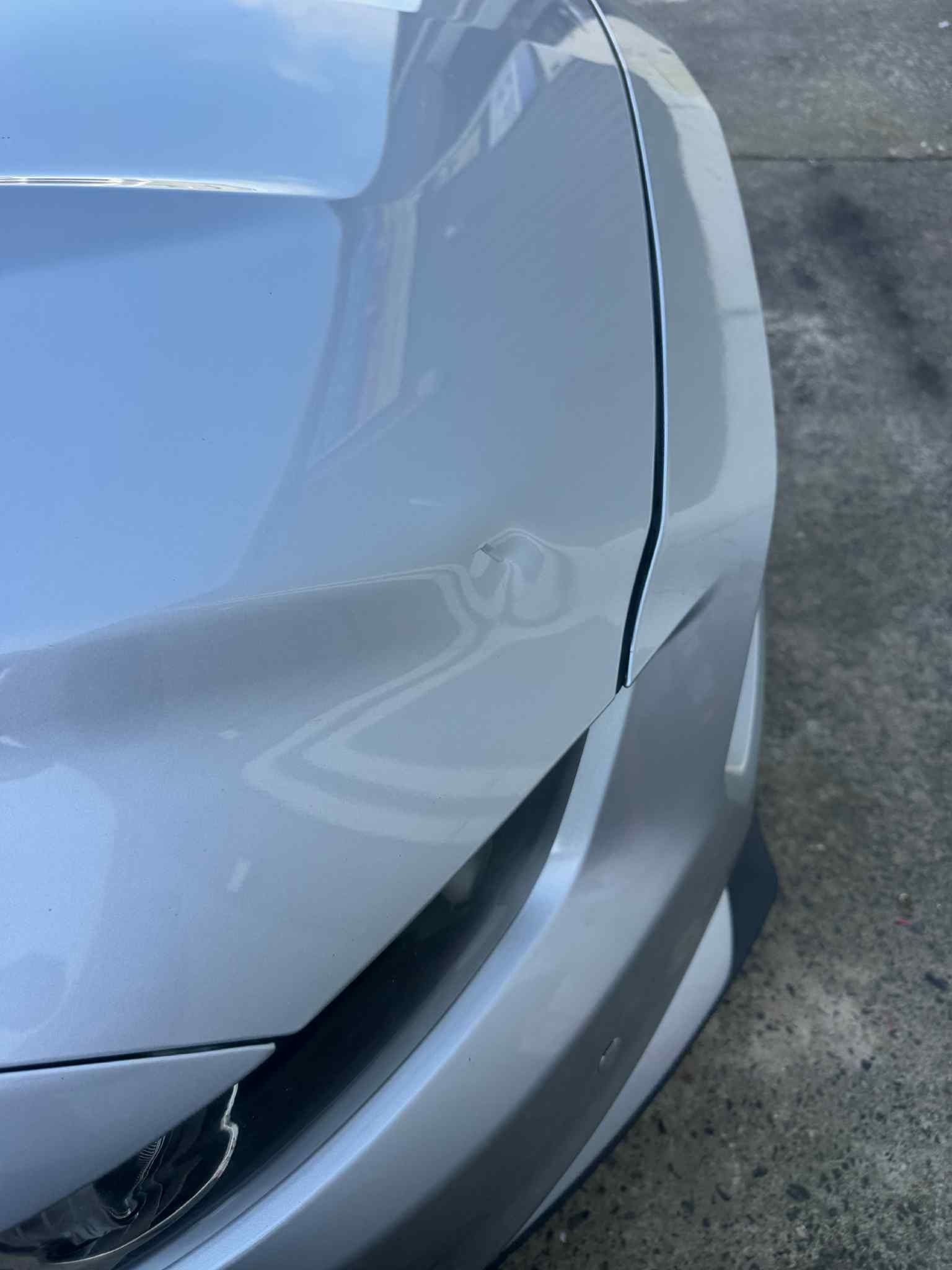 Close-up of a White Car’s Front Bumper — A2B Smash Repairs in Berkeley Vale, NSW