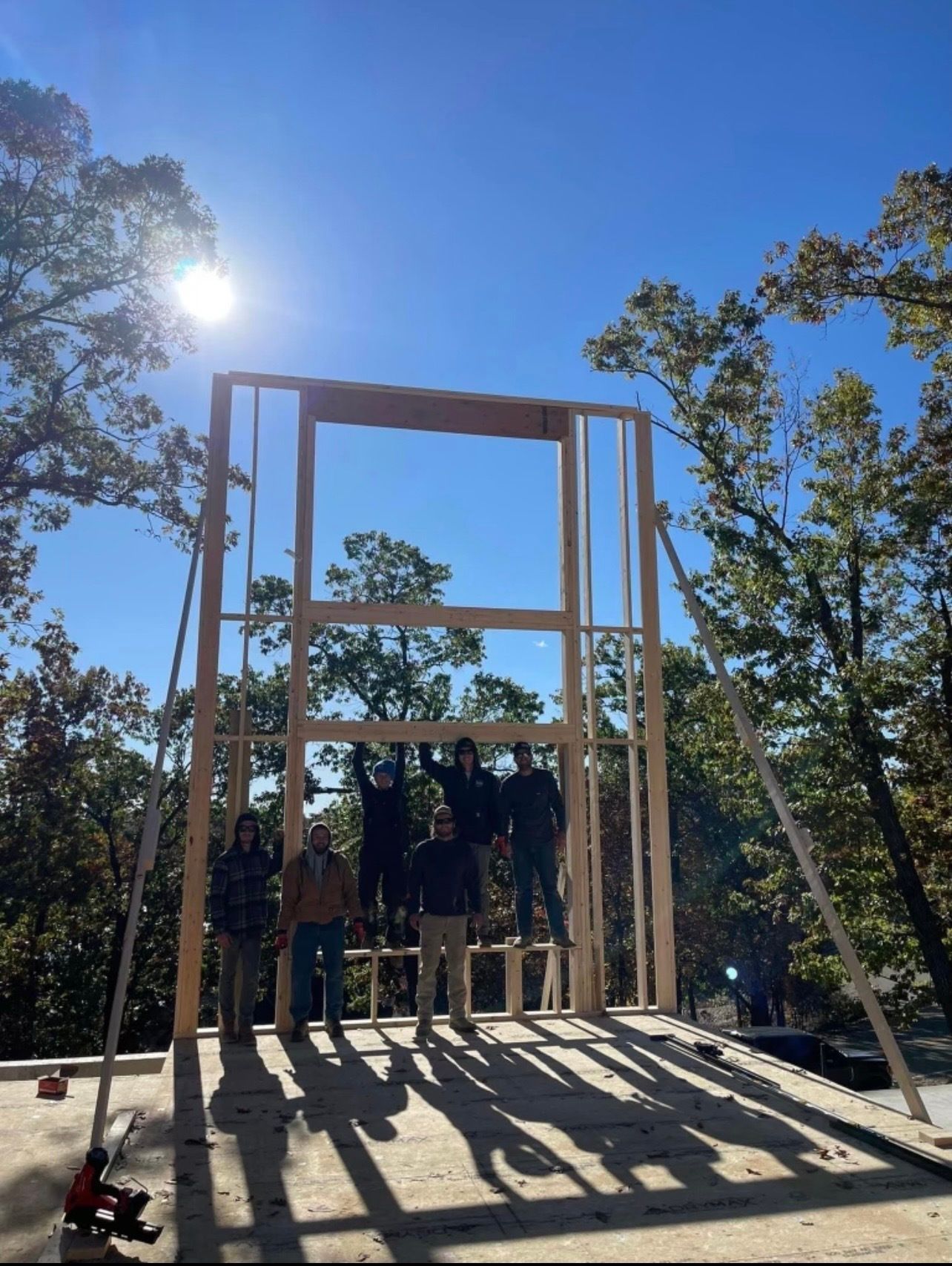 A group of people standing on top of a wooden structure