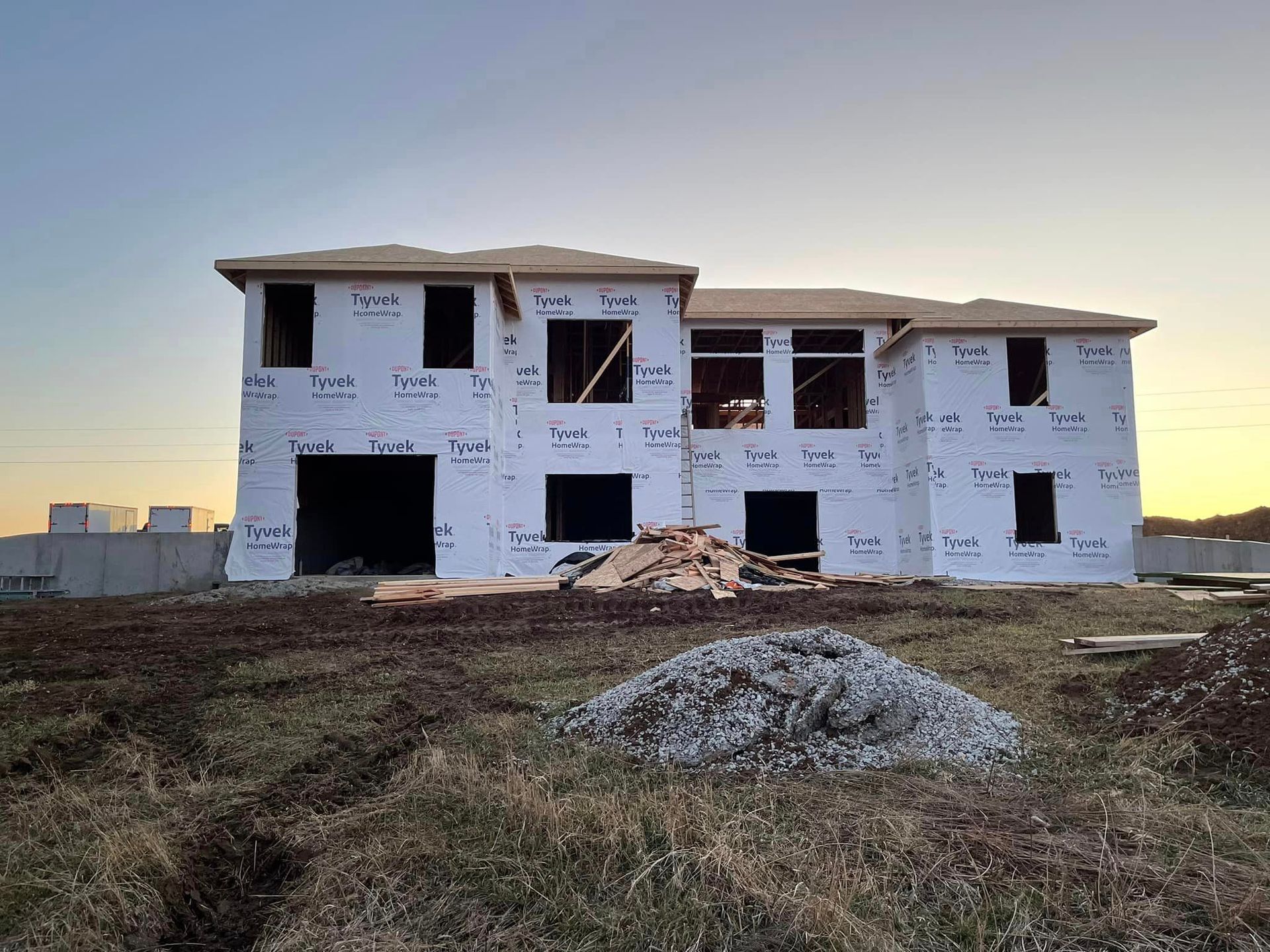 A large house is being built in a field.