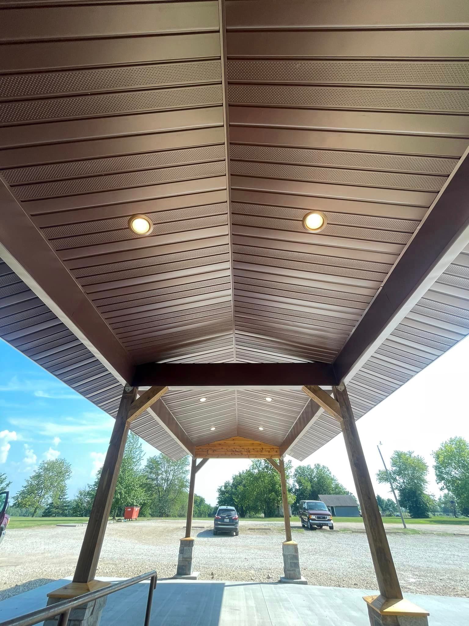 The ceiling of a building with a car parked underneath it.