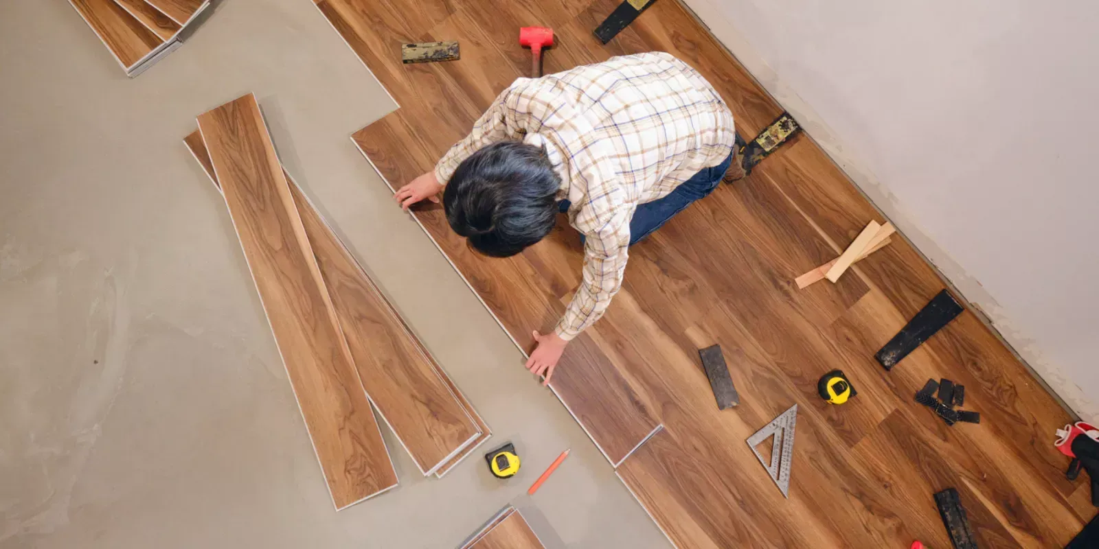 Two men are working on a ceiling in a bathroom.