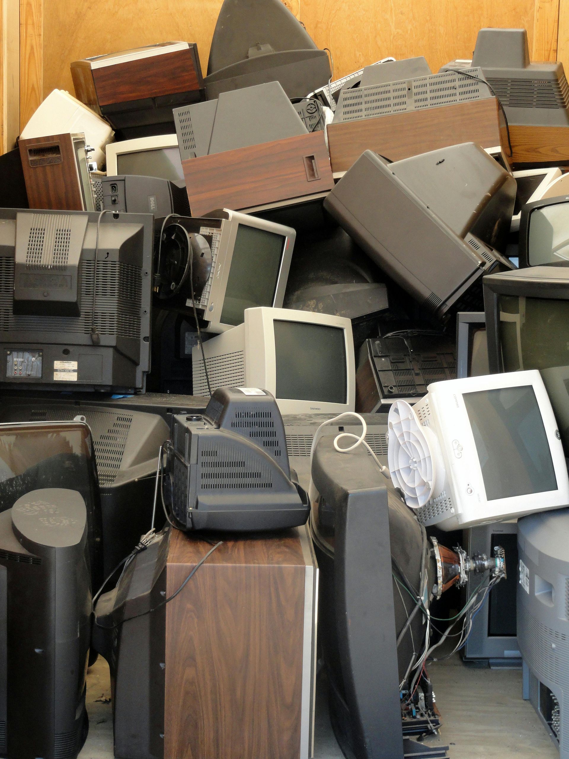 A bunch of old televisions are stacked on top of each other