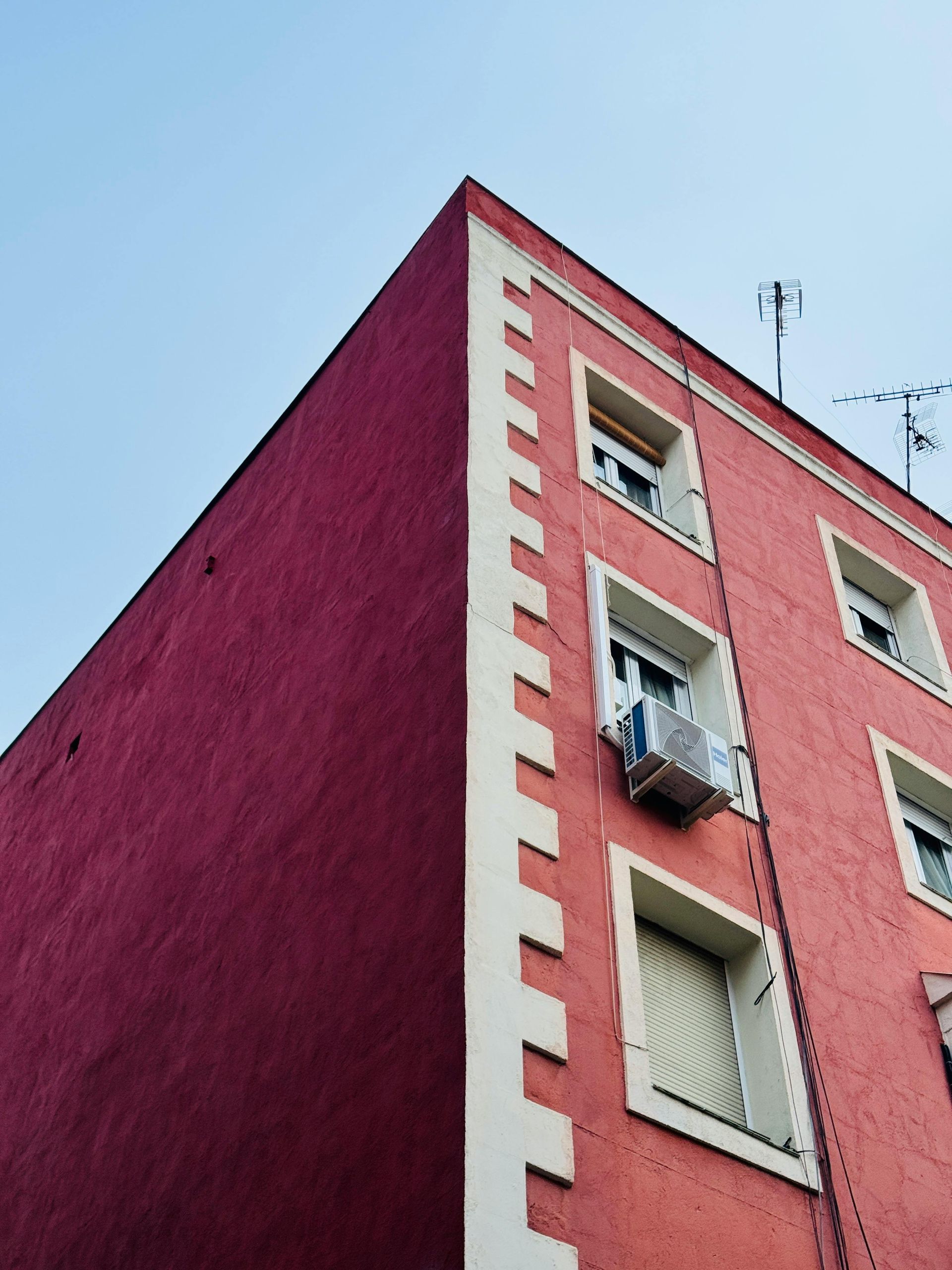 An ac unit is mounted to a brick wall
