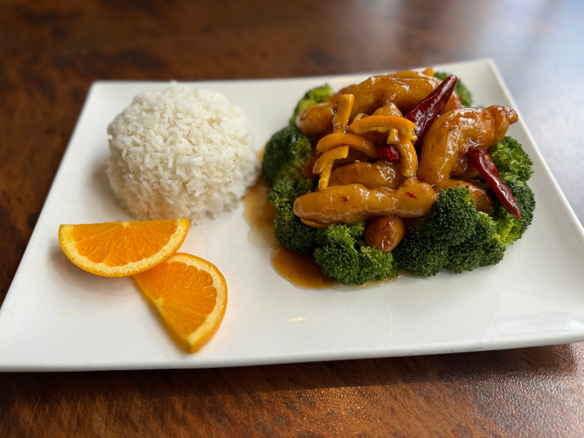 A plate of food with broccoli and rice on a table.