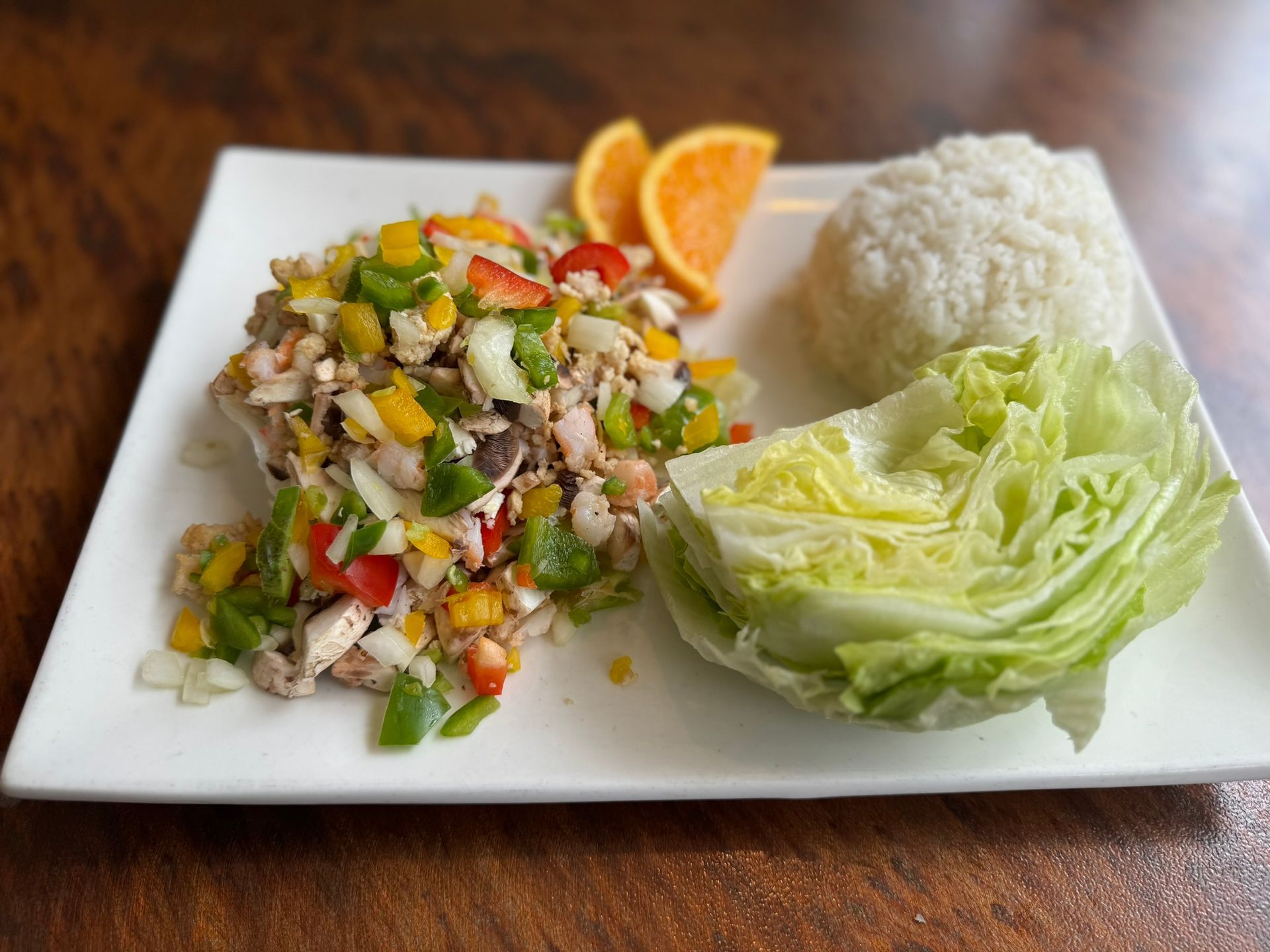 A plate of food with lettuce and rice on a table.