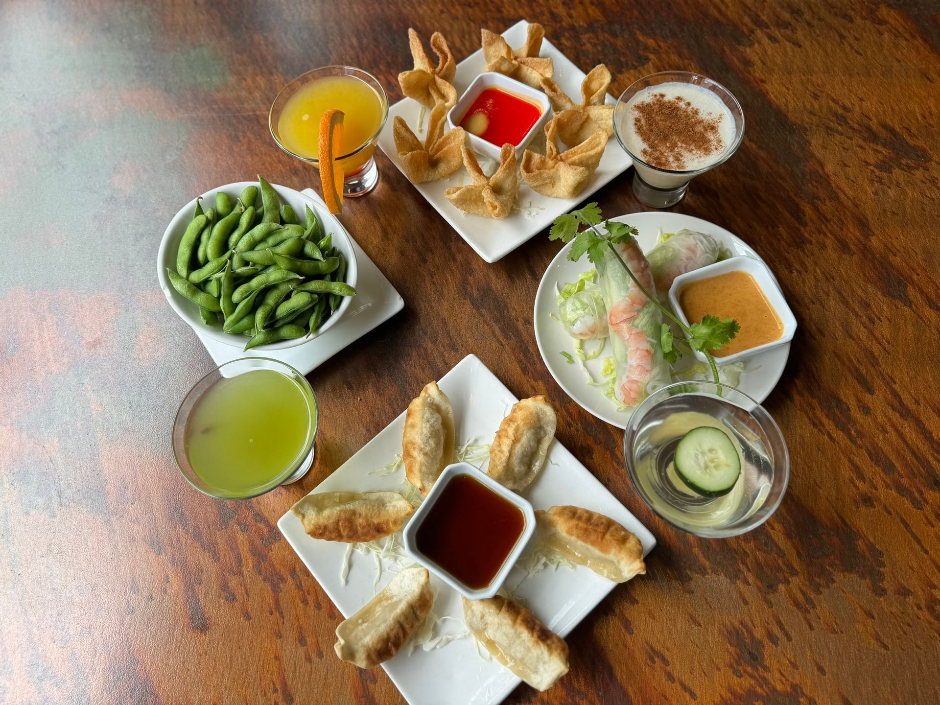 A table topped with plates of food and drinks.