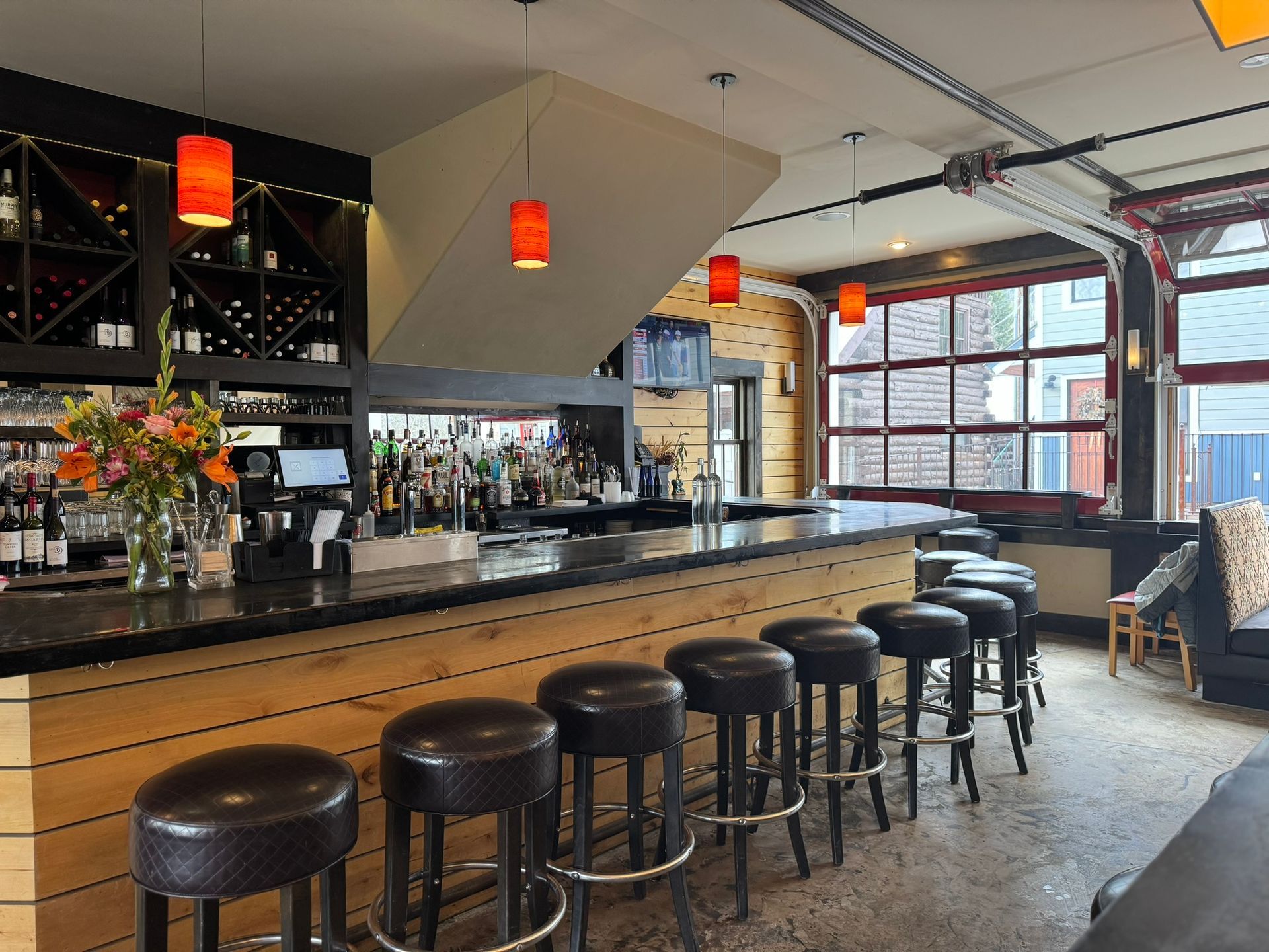 A restaurant with a long bar and stools