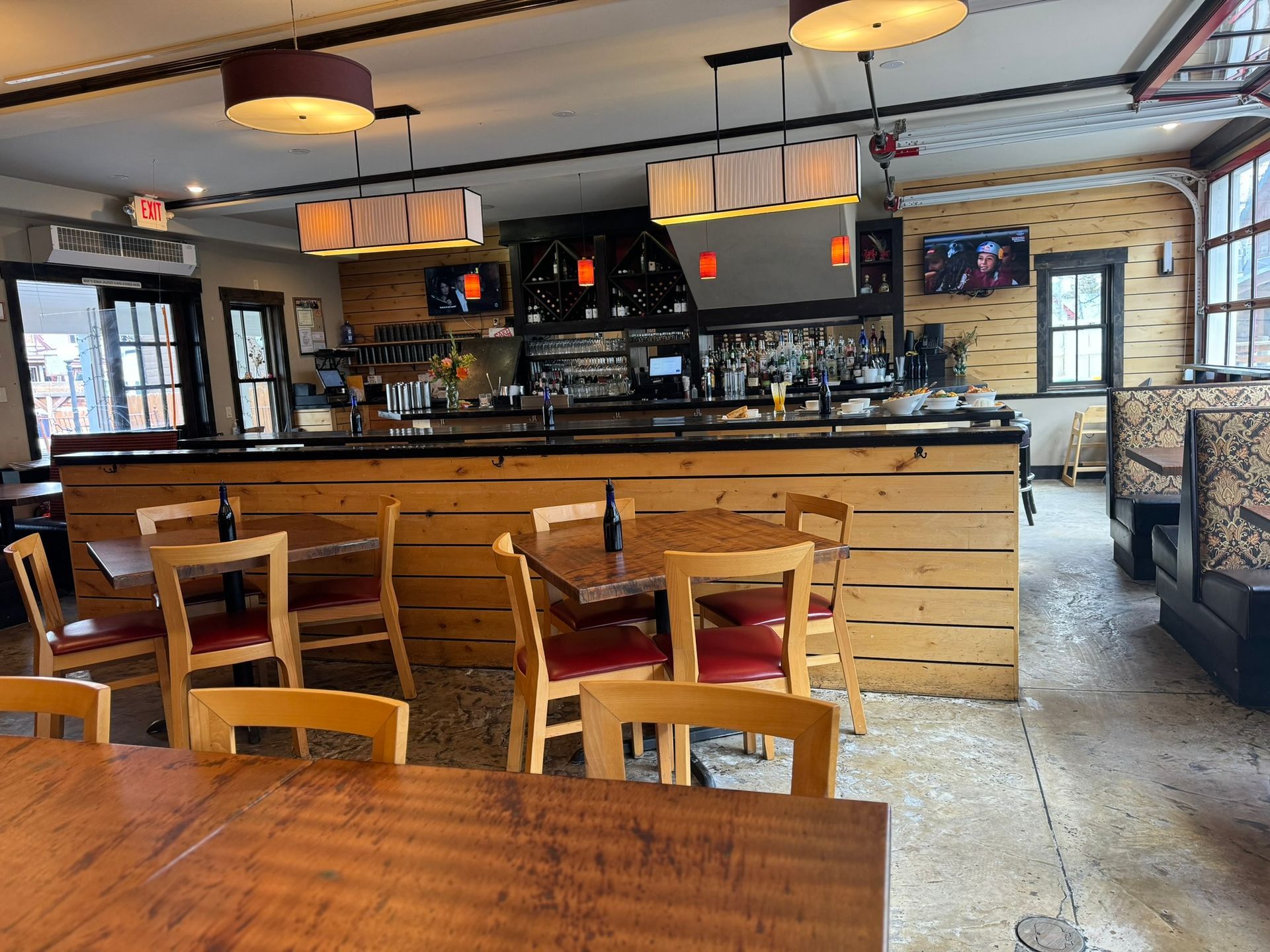 A restaurant with tables and chairs and a bar