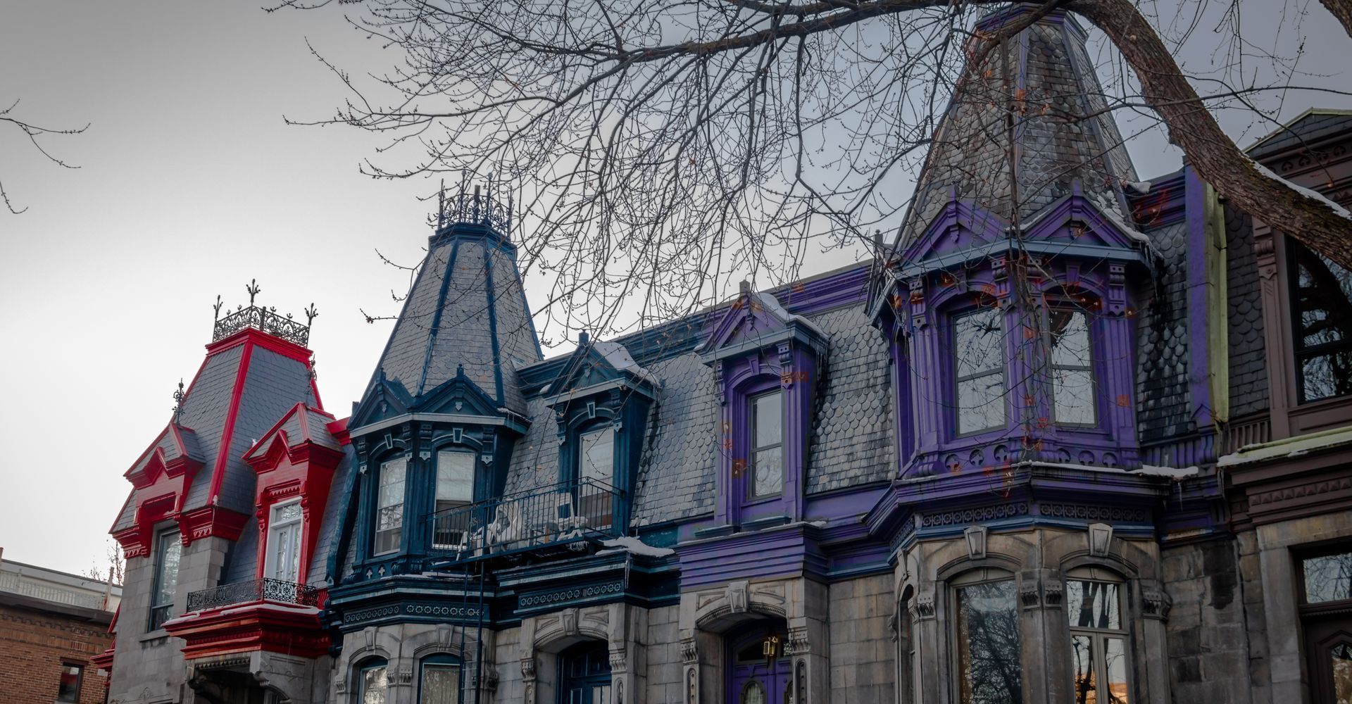 A row of colorful houses on a city street.