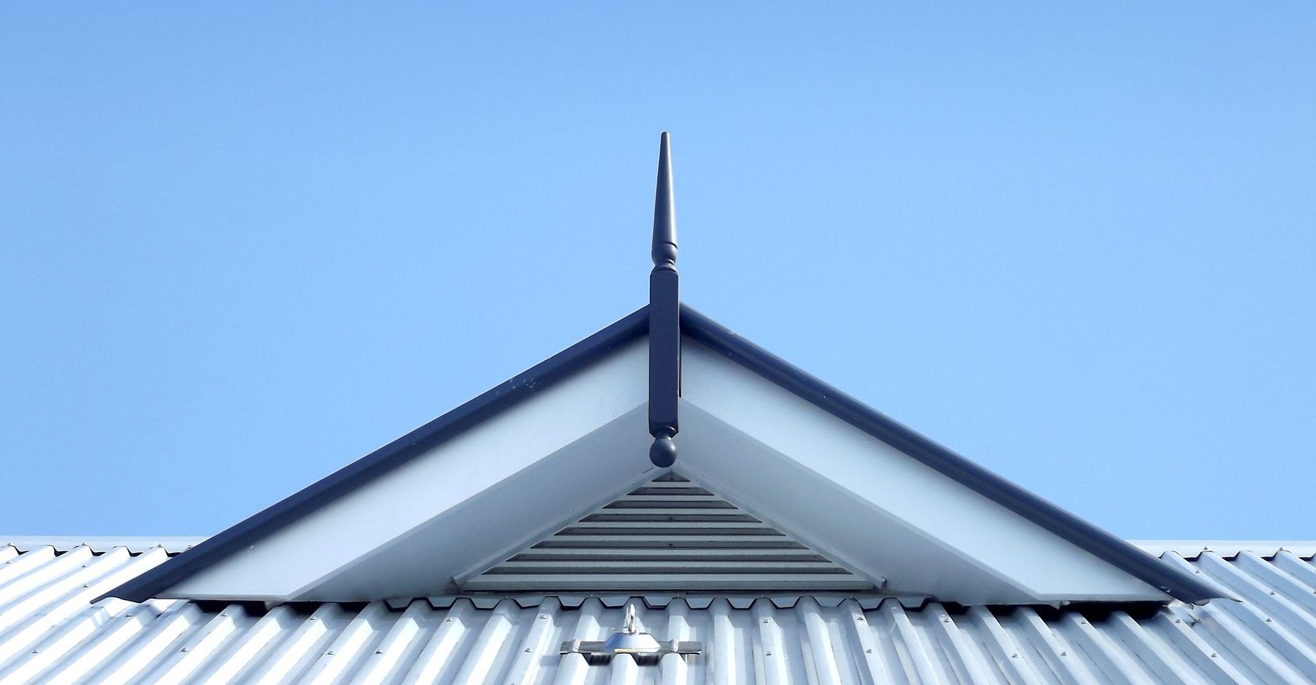 The roof of a building with a blue sky in the background