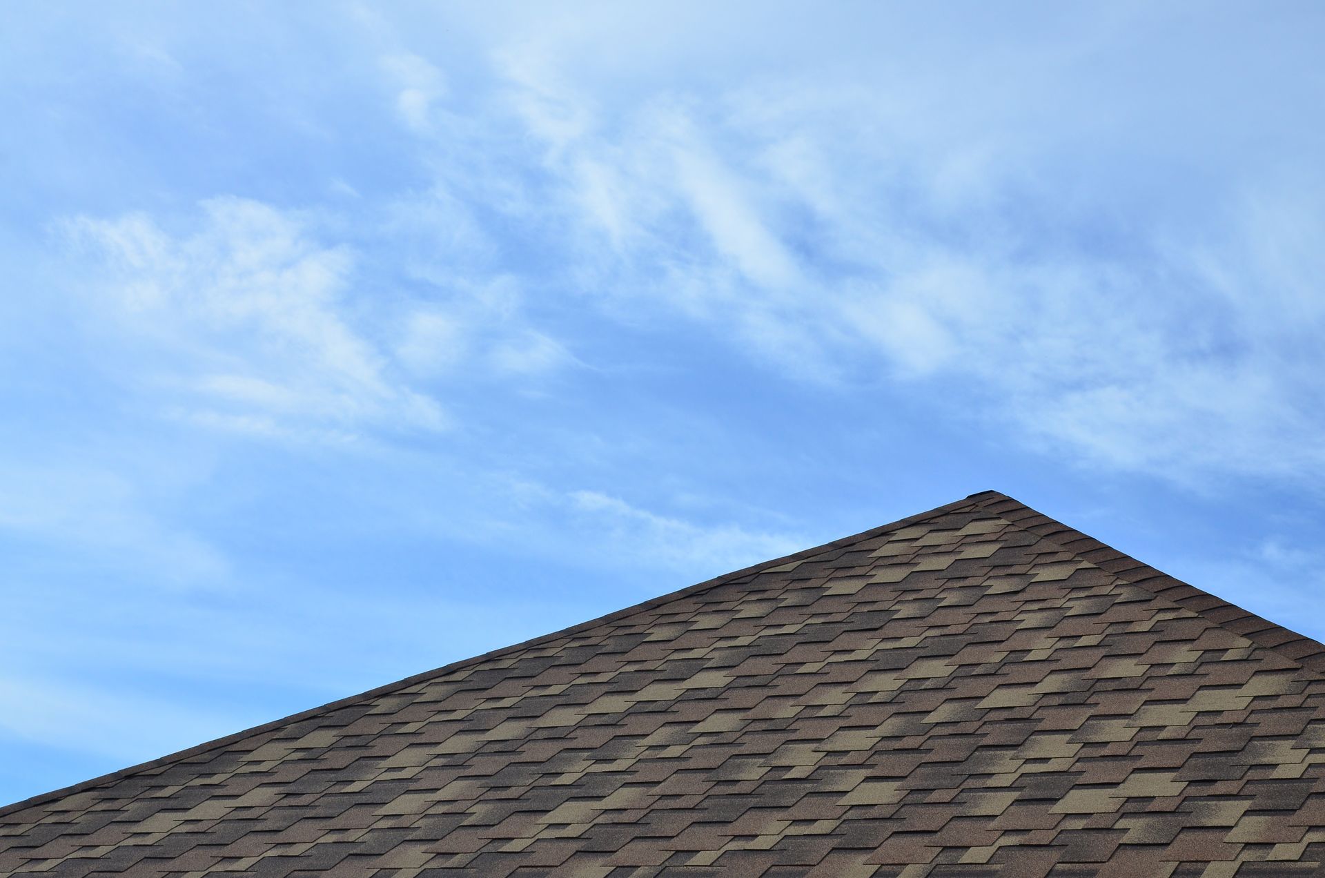 A close up of a roof with a blue sky in the background.