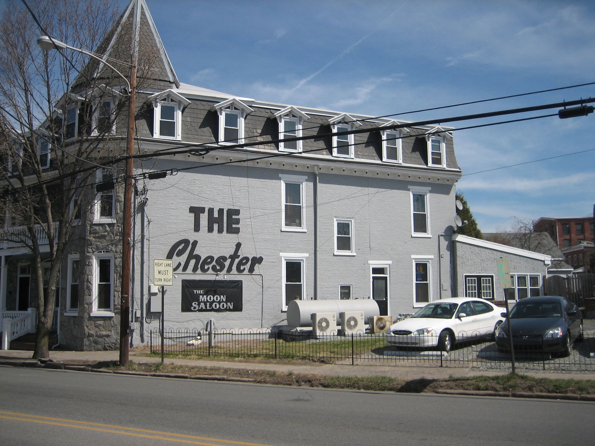 A gray building with a sign that says the chester