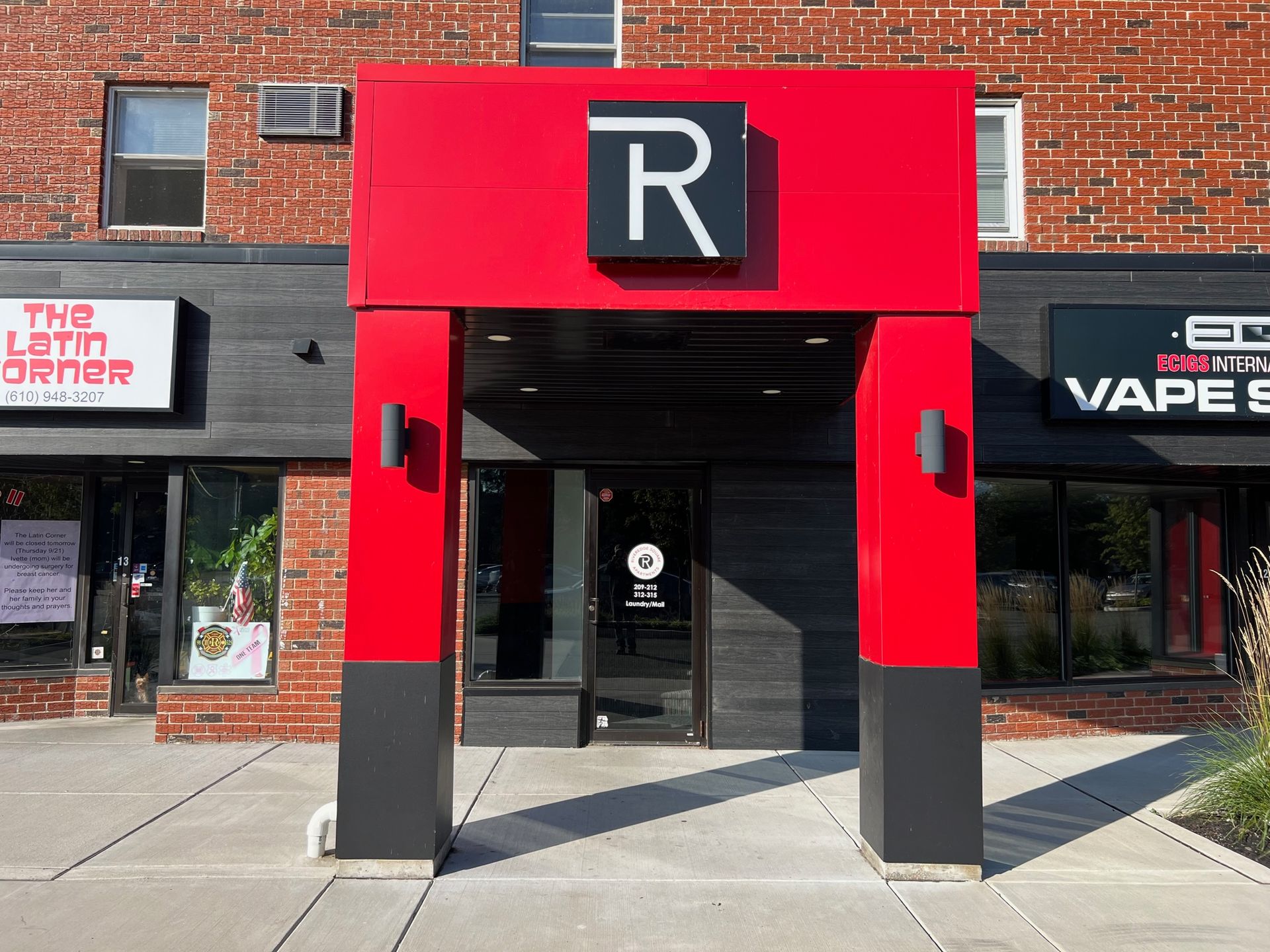 A red and black building with a sign that says r on it.