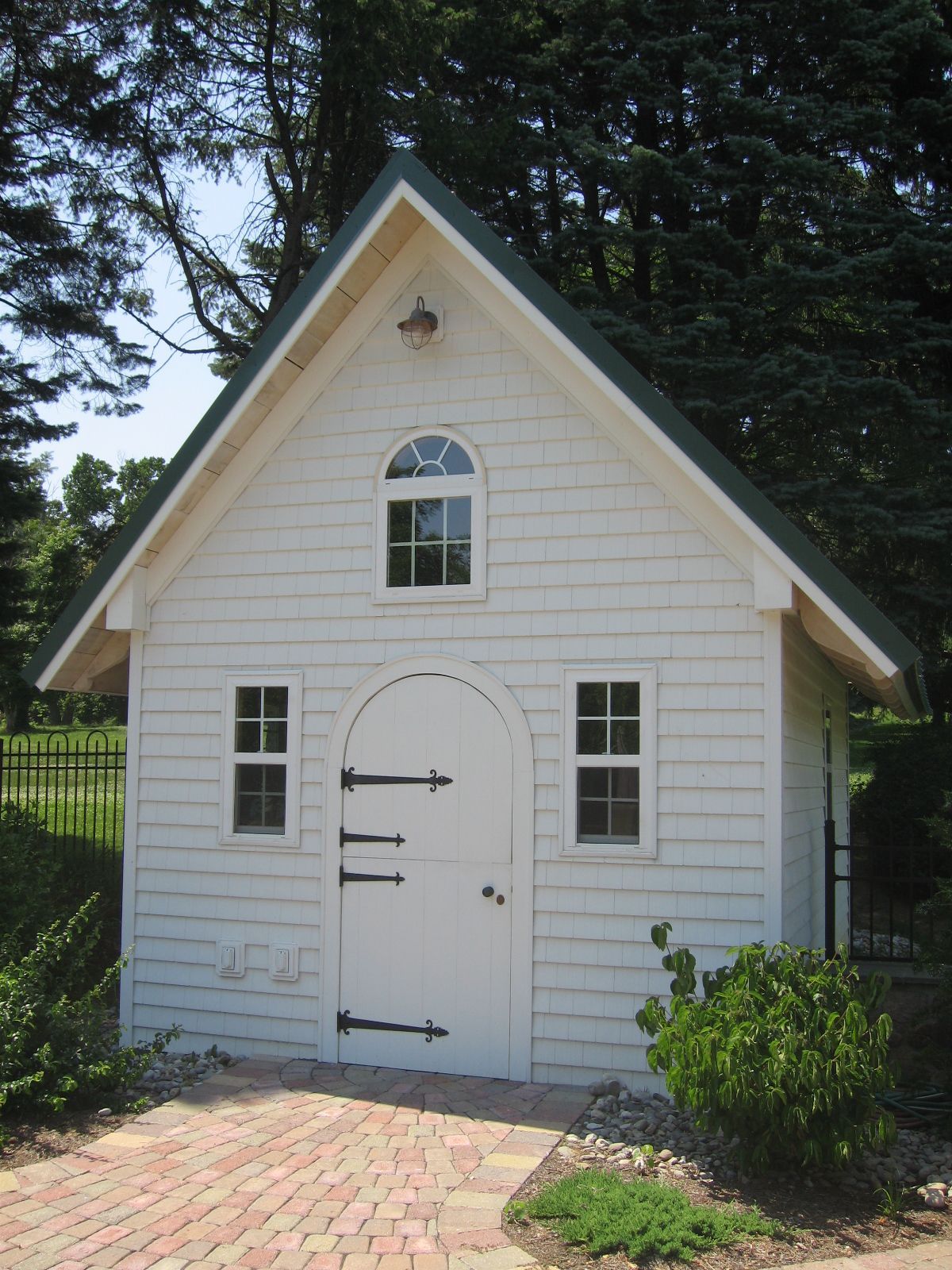 A small white house with a green roof
