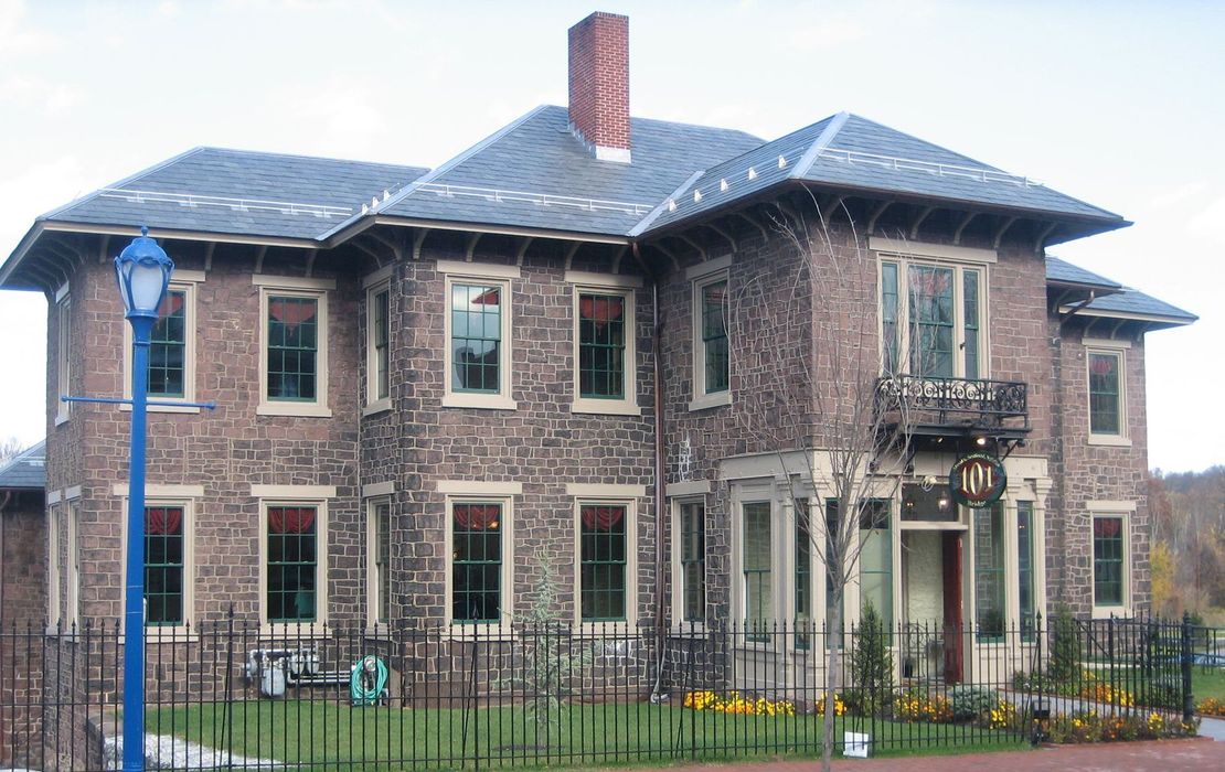 A large brick building with a blue lamp post in front of it