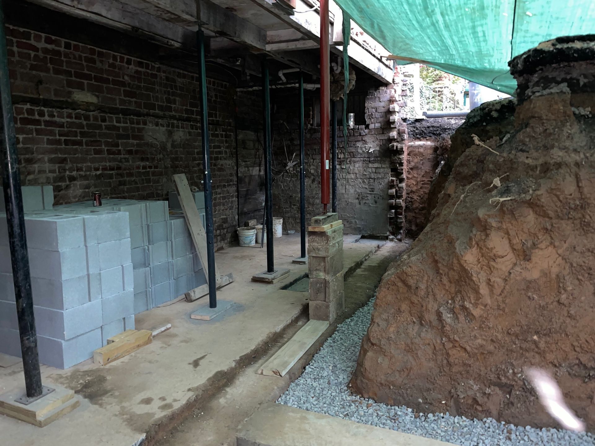 A concrete wall is being built in front of a house.