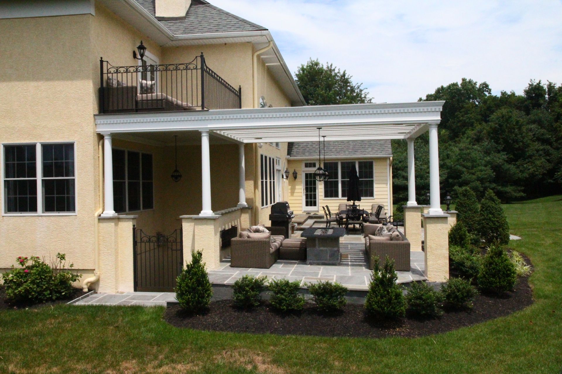 A house with a covered patio and a balcony