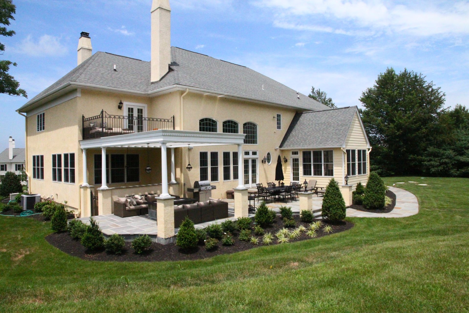 A large house with a large patio in front of it