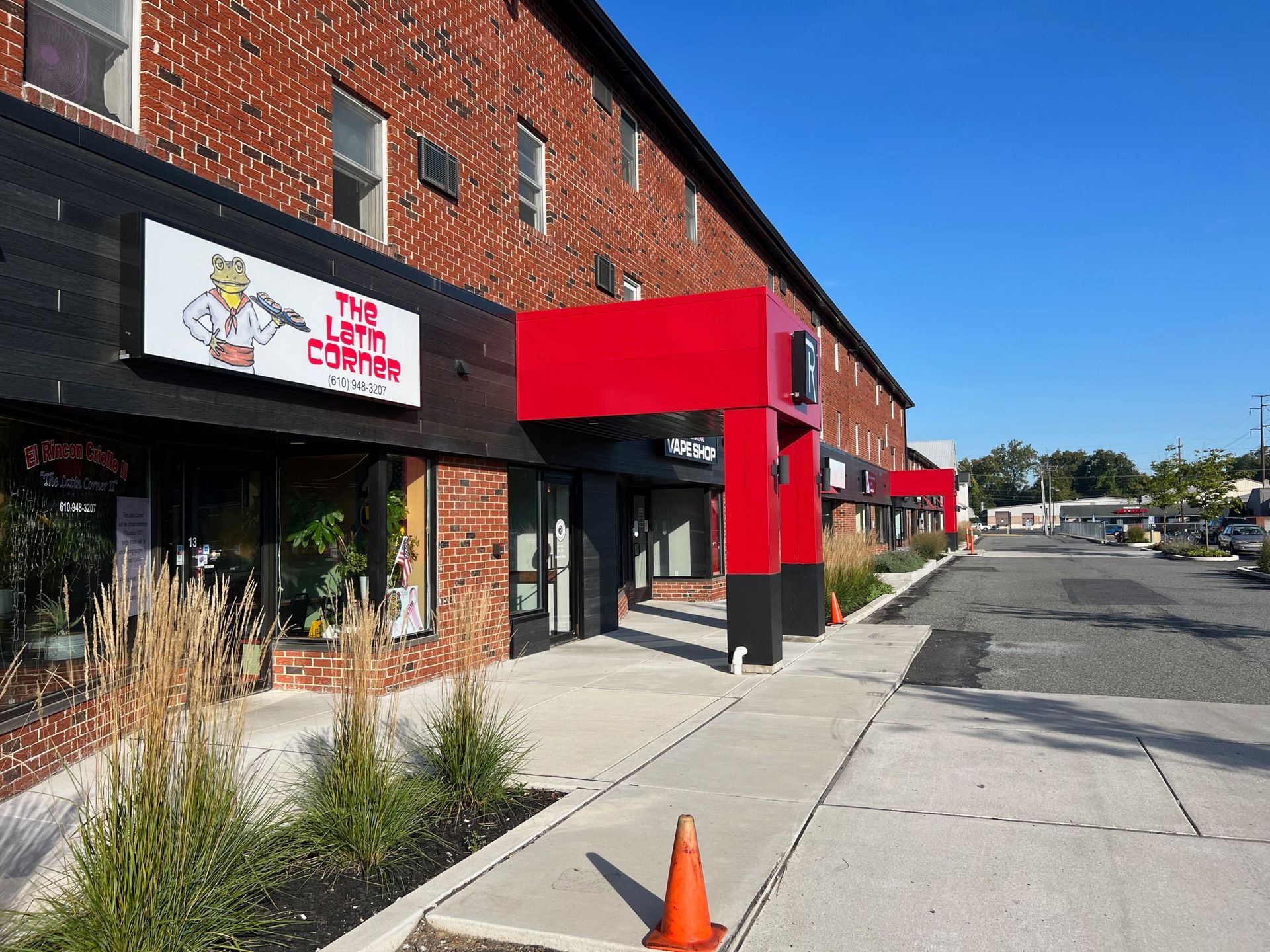 A brick building with a red awning over the entrance to a restaurant.