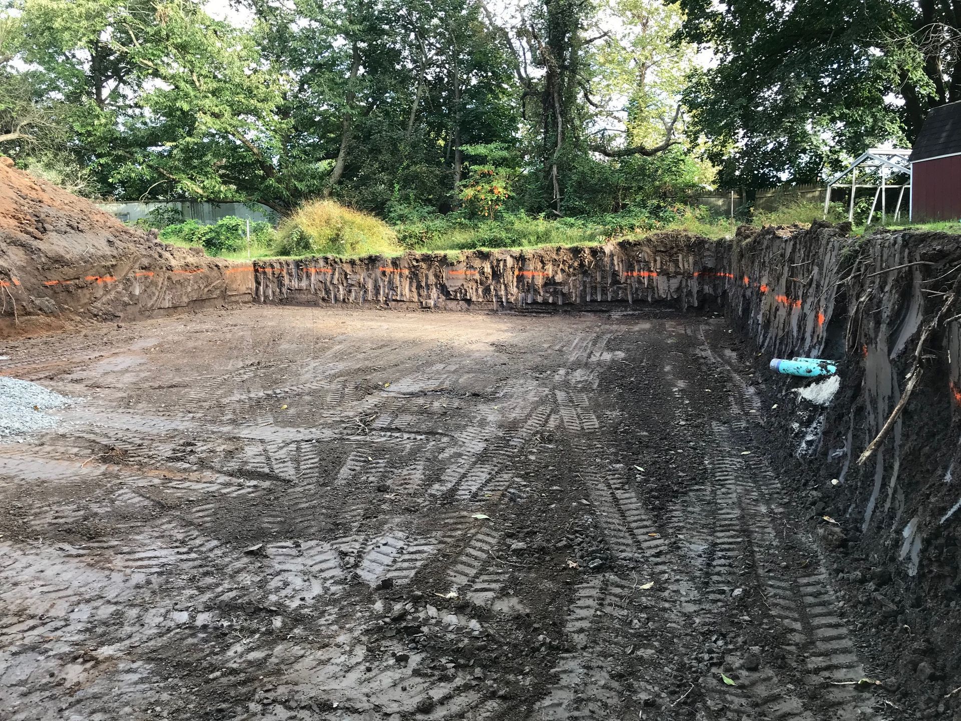 A large pile of dirt is sitting in the middle of a dirt field.