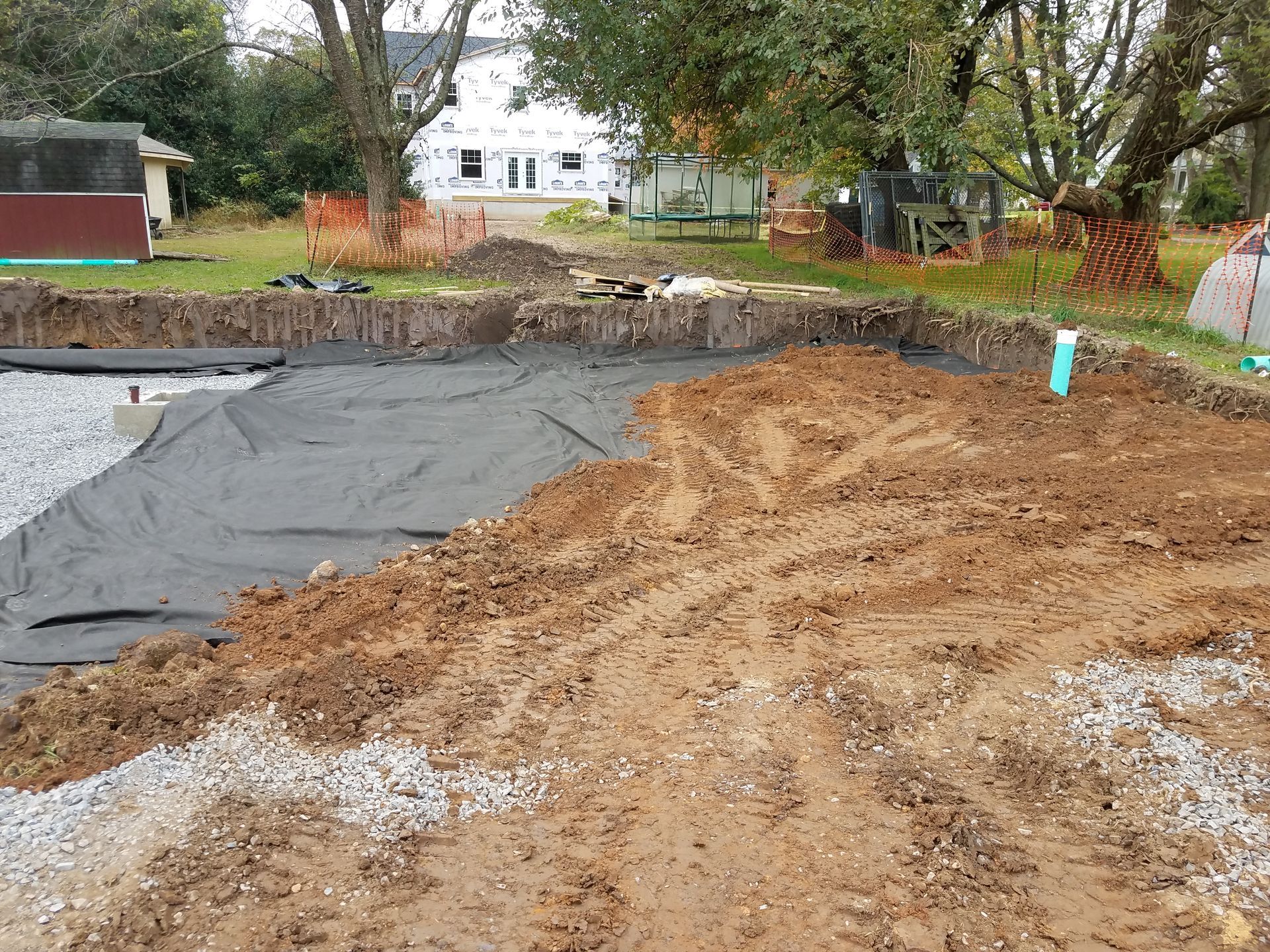 A large pile of dirt is sitting in the middle of a dirt field.