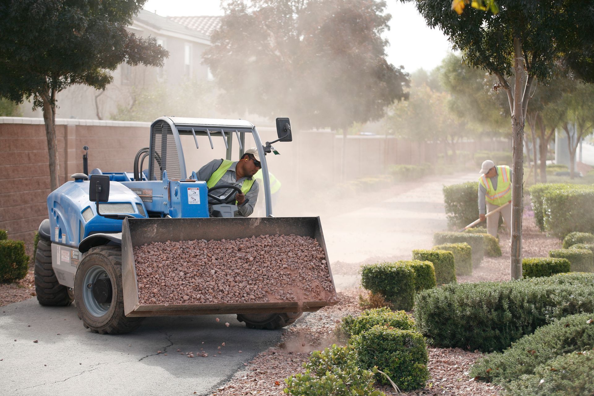 A man is driving a bulldozer on a dirt road