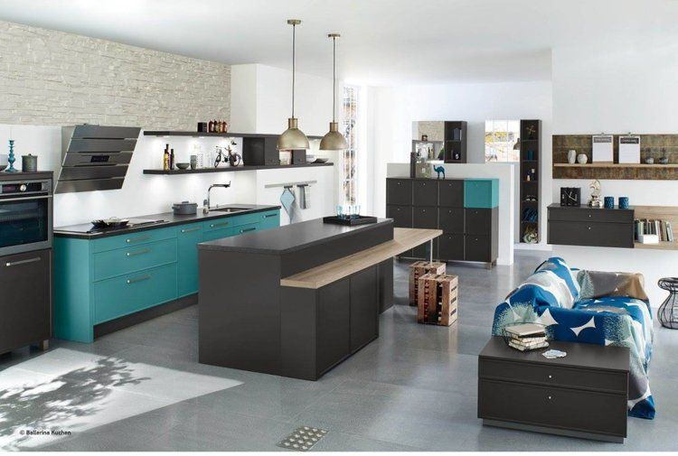 A kitchen with turquoise cabinets and black counter tops