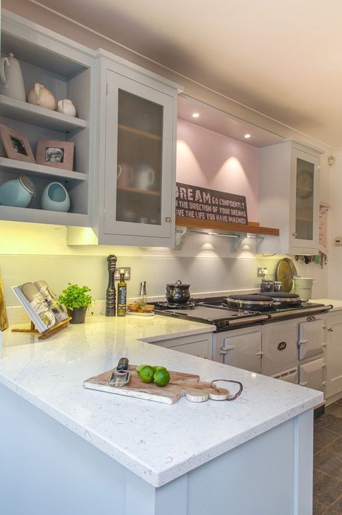 A kitchen with white cabinets and a stove top oven.