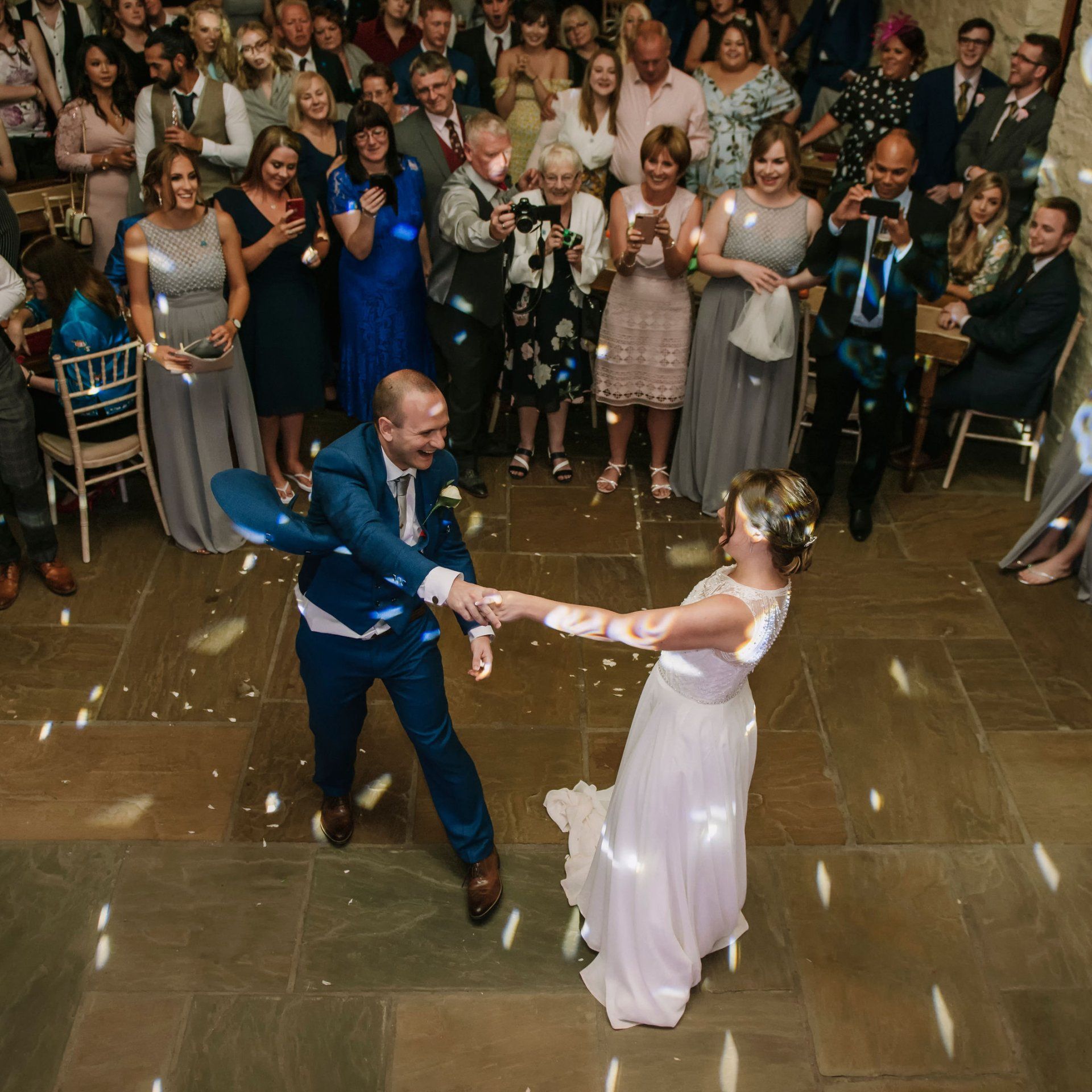 a couple having their first dance in the barn