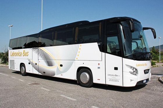 White bus with black roof and grey, black and yellow wing design in the side seen from the front