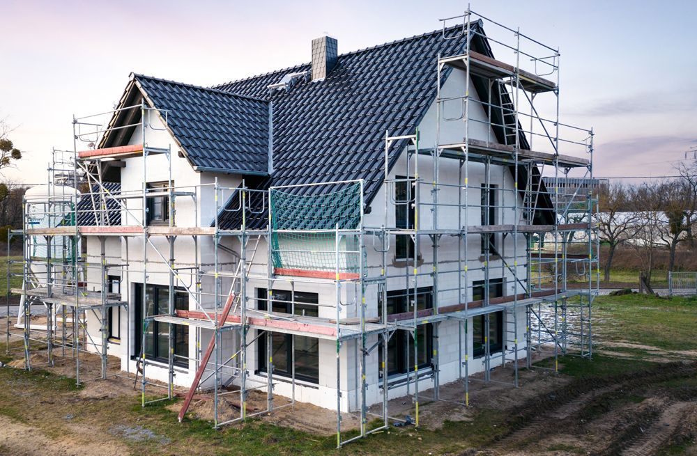 A house is being built with scaffolding around it.