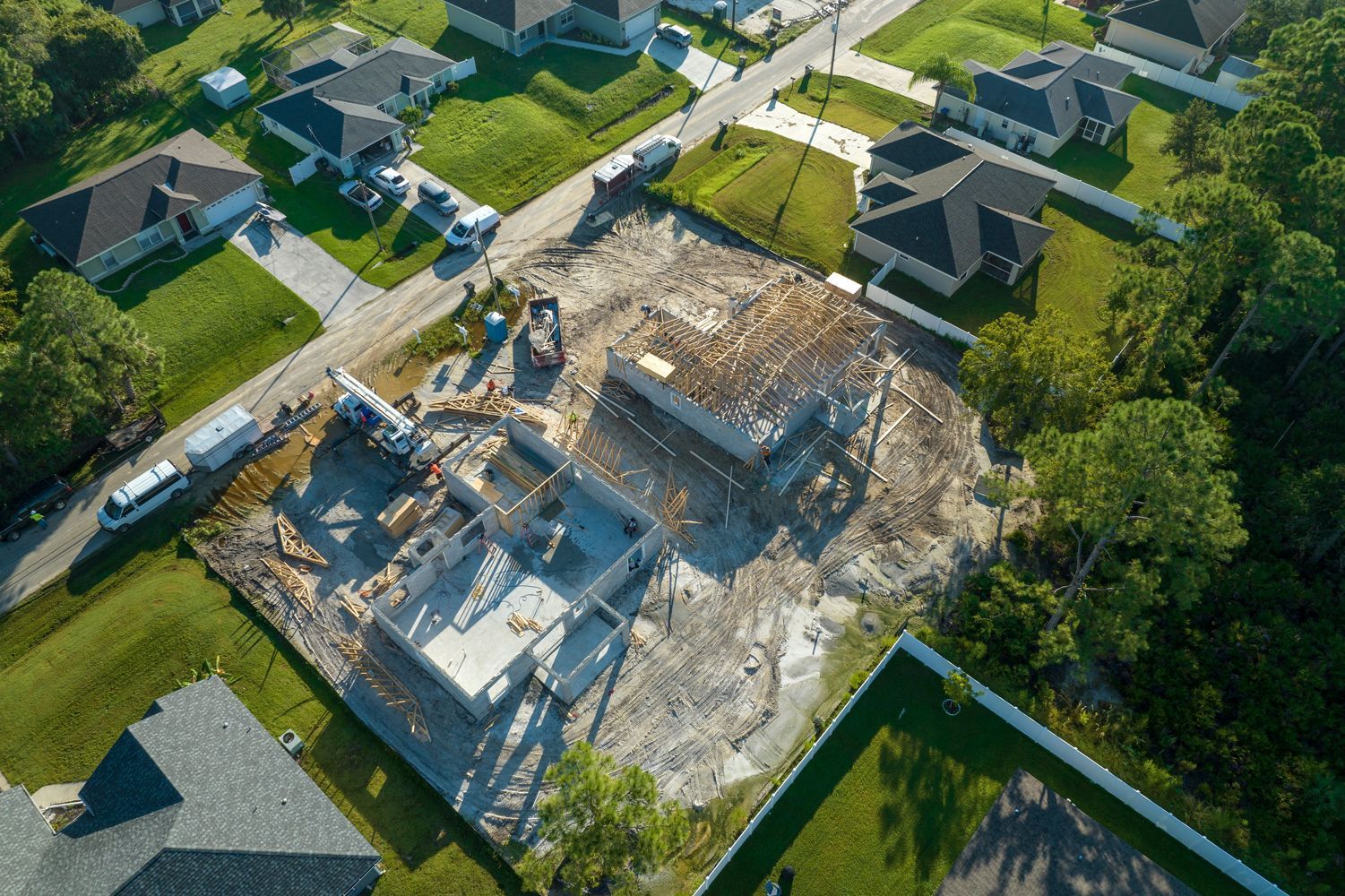 An aerial view of a house under construction in a residential neighborhood.