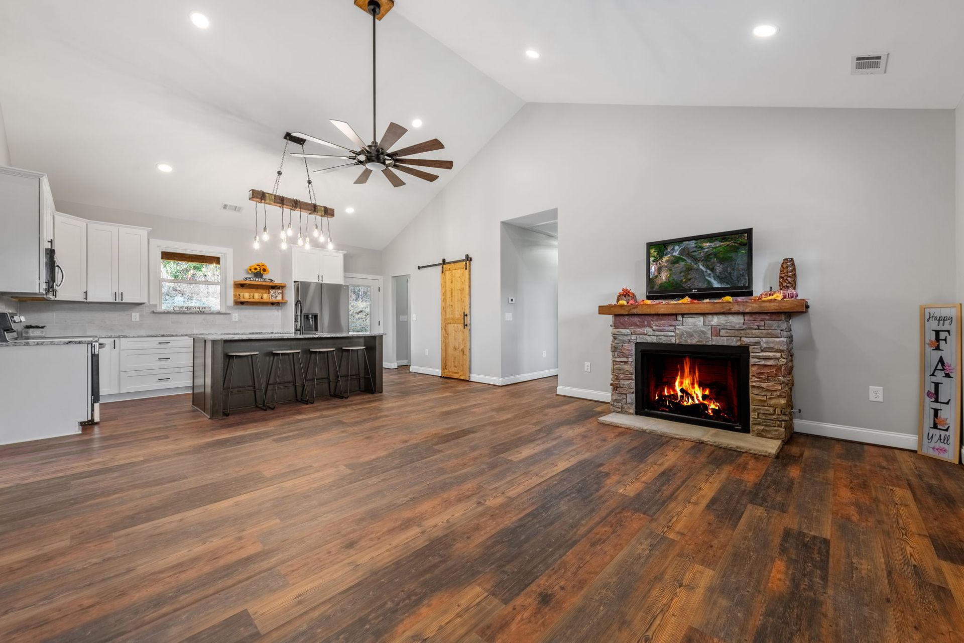 A living room with hardwood floors and a fireplace.