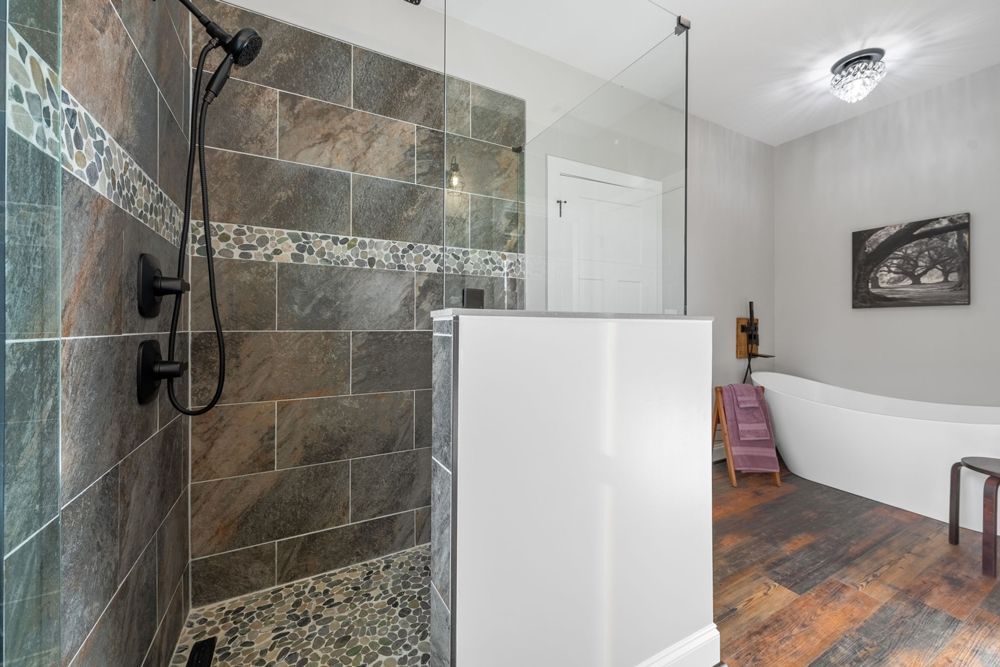 A bathroom with a walk in shower and a bathtub.