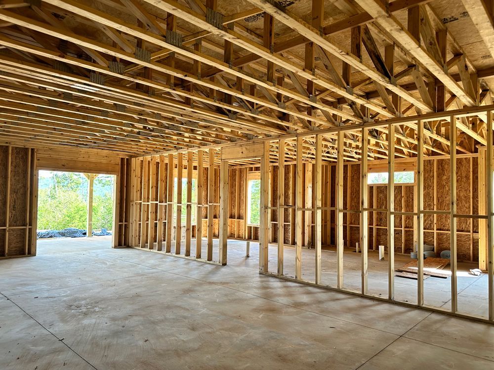 The inside of a house under construction with wooden beams.