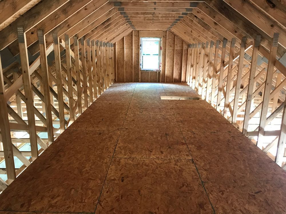 The attic of a house under construction with a window