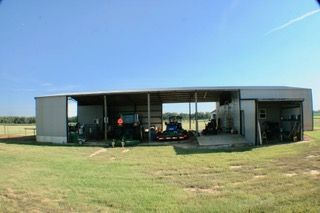 A large building with a lot of vehicles parked inside of it.