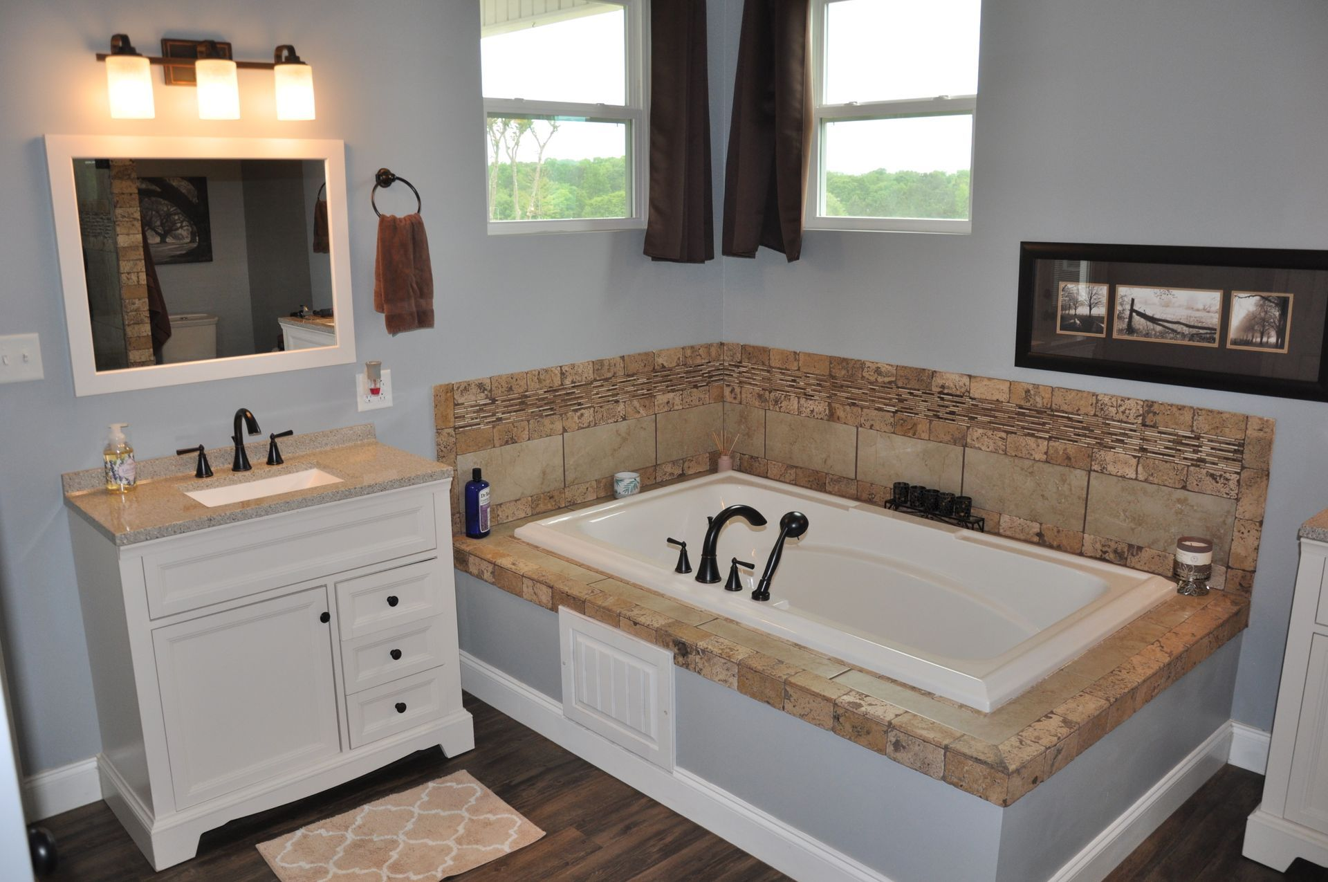 A bathroom with a bathtub , sink and mirror