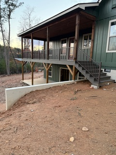 A green house with stairs leading up to it