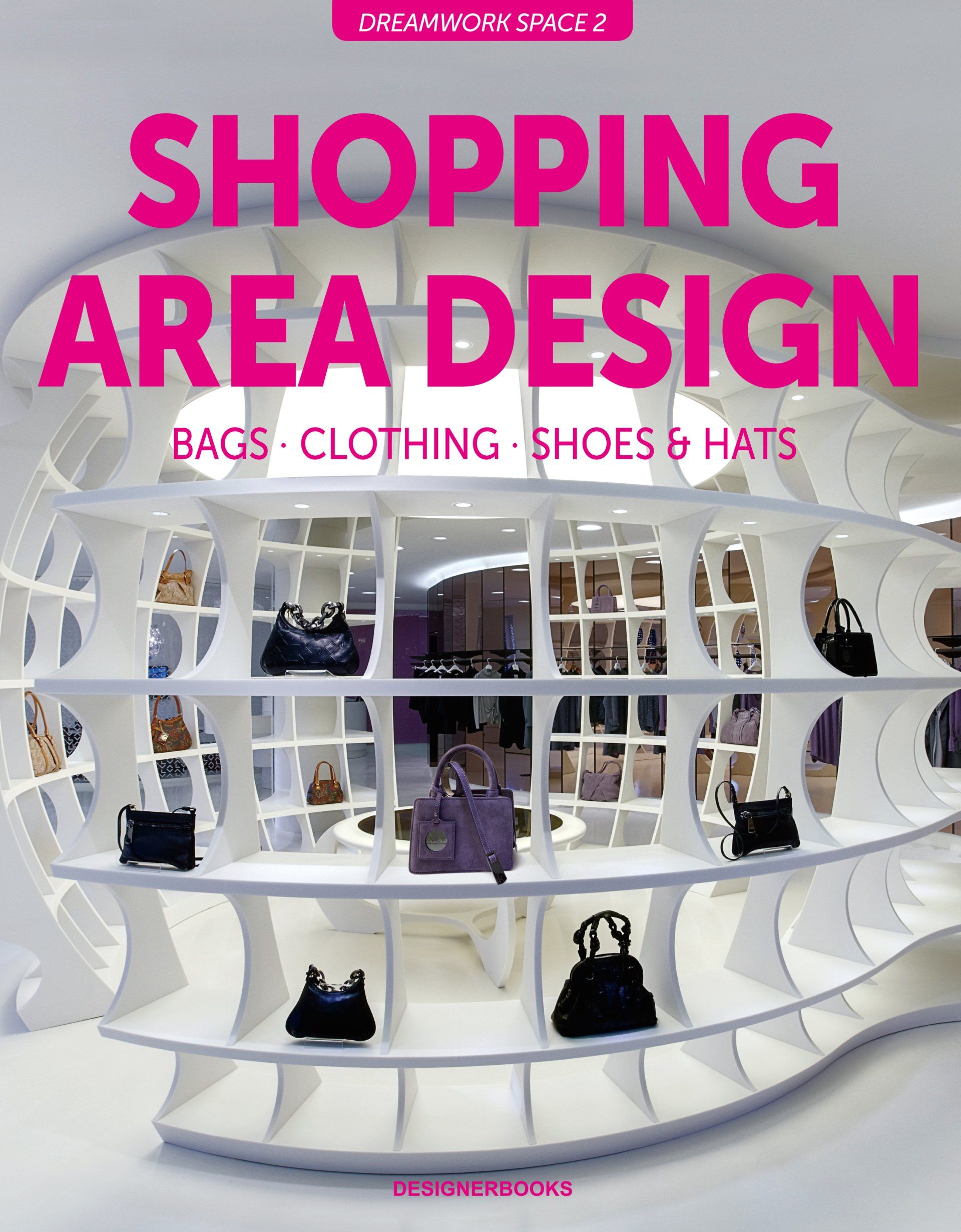 Un libro titulado Diseño de áreas comerciales muestra una exhibición de bolsos, ropa, zapatos y sombreros.