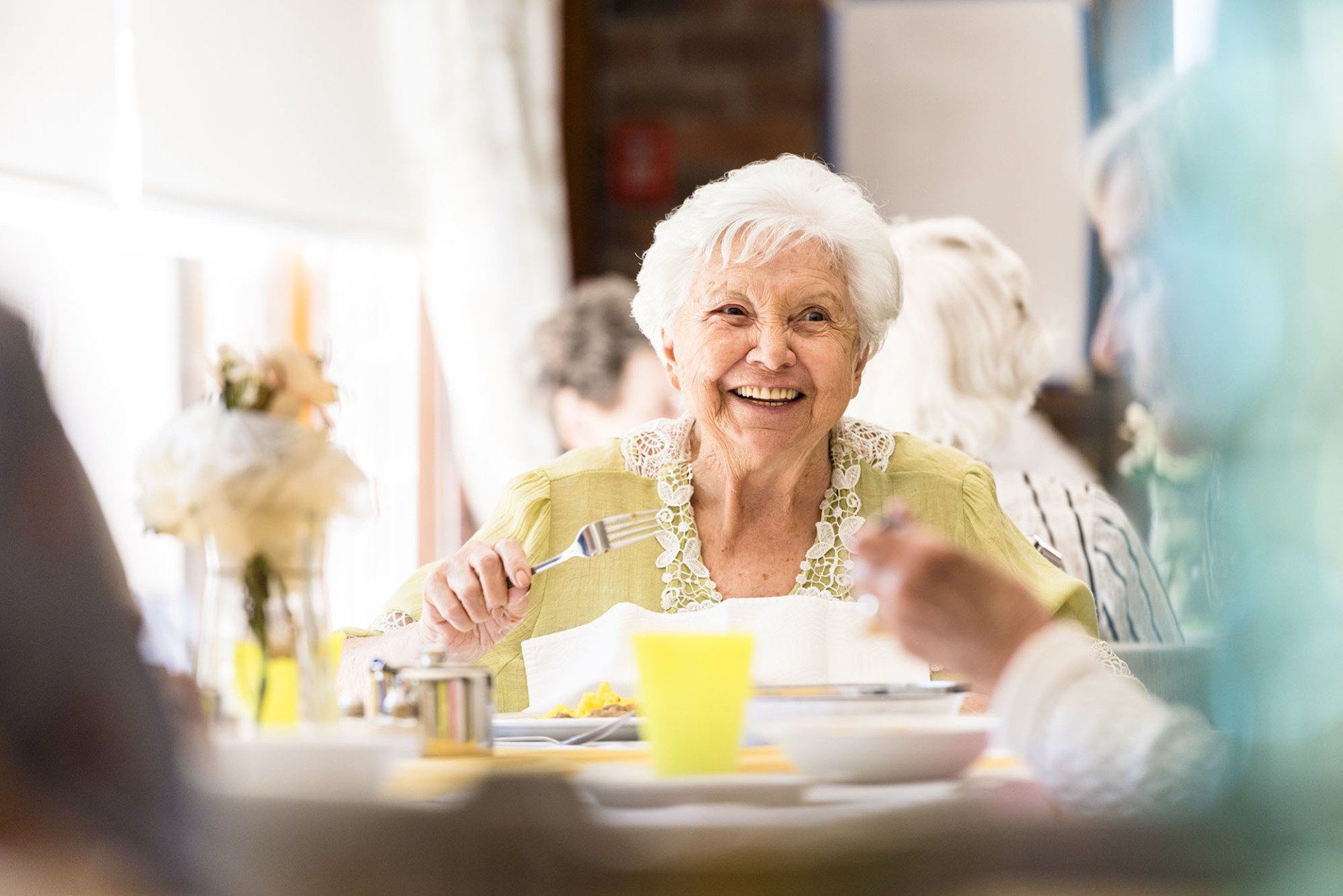 Woman smiling eating lunch